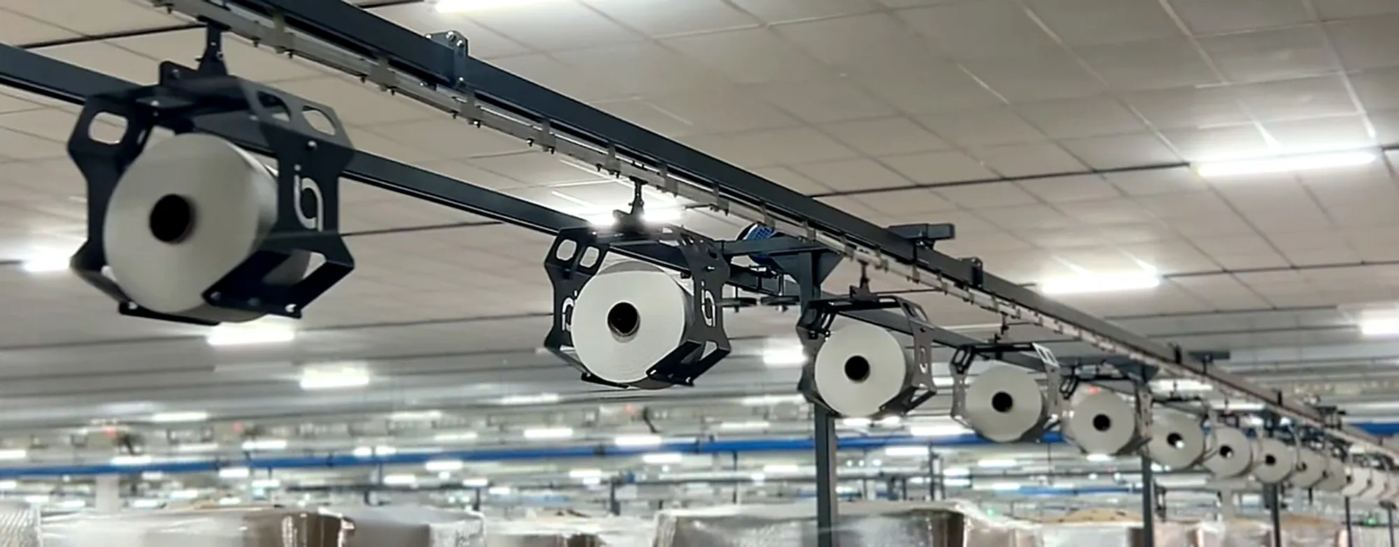 Indo Texnology cone transport system carrying yarn packages in a spinning mill